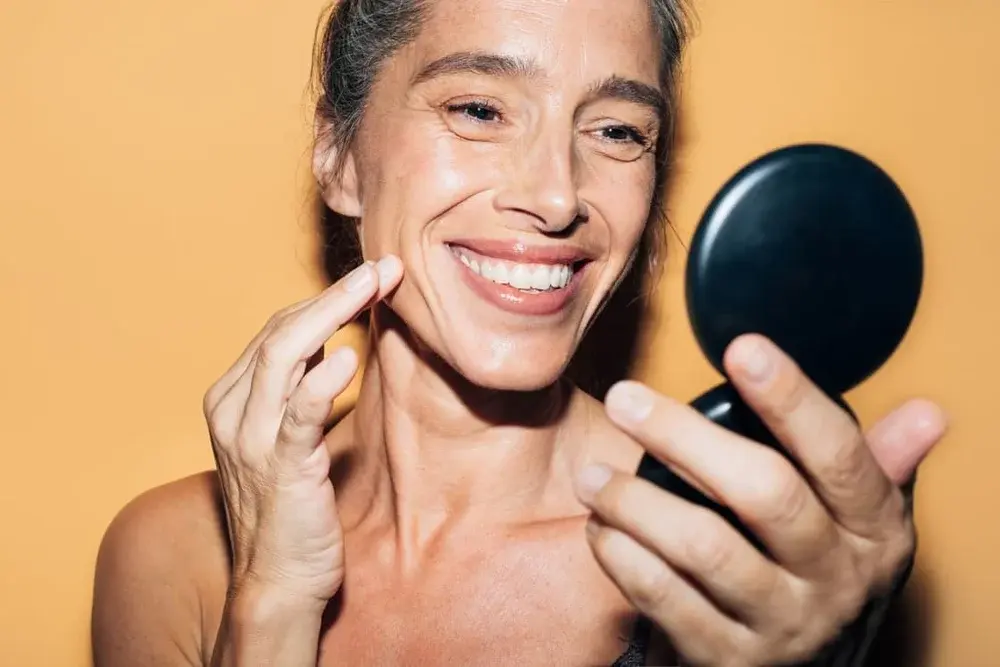 5 Surprising Tips For Disguising Gray Hairs, From Highlights To Spot Treatments